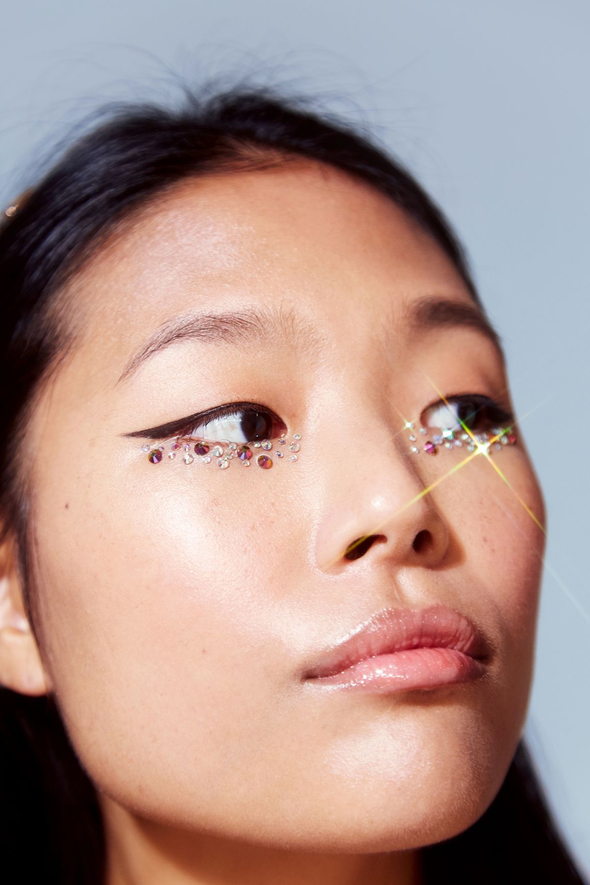 Close-up portrait with sparkly gem eye makeup